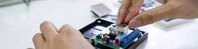 Technician checks the electronic device. Printed circuit board for the robot.